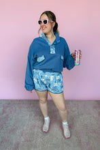 Load image into Gallery viewer, Person wearing a blue floral matching outfit holding a colorful drink can against a pink background