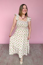 Load image into Gallery viewer, Woman wearing a pink and geeen floral midi dress against a pink background