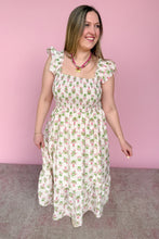 Load image into Gallery viewer, Woman wearing a pink and green floral midi dress against a pink background