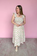 Load image into Gallery viewer, Woman wearing a pink and green floral midi dress against a pink background