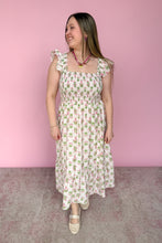 Load image into Gallery viewer, Woman wearing a pink and green floral midi dress against a pink background