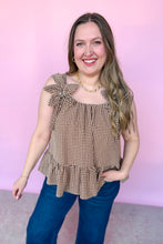 Load image into Gallery viewer, Girl wearing a brown gingham babydoll tank with dark denim jeans in front of a pink backdrop.