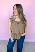 Load image into Gallery viewer, Girl wearing a brown gingham babydoll tank with dark denim jeans in front of a pink backdrop.