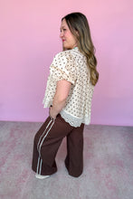 Load image into Gallery viewer, Girl wearing brown wide leg pants with cream and brown polkadot top in front of a pink backdrop.