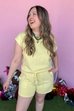 Load image into Gallery viewer, Girl wearing a yellow set with matching shorts and short sleeve top with a pink backdrop.