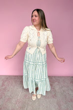 Load image into Gallery viewer, Woman wearing a vintage-style outfit with a pink background