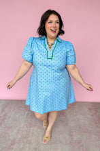 Load image into Gallery viewer, Woman wearing a light blue dress with green polka dots against a pink background