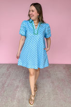 Load image into Gallery viewer, Woman wearing a light blue dress with green polka dots against a pink background