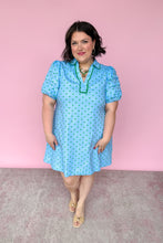Load image into Gallery viewer, Woman wearing a light blue dress with green polka dots against a pink background