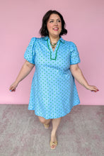Load image into Gallery viewer, Woman wearing a light blue dress with green polka dots against a pink background