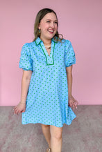 Load image into Gallery viewer, Woman wearing a blue dress with green polka dots against a pink background