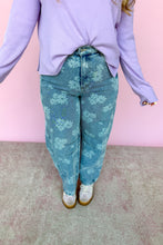 Load image into Gallery viewer, Person wearing a light purple sweater and denim floral jeans against a pink wall.