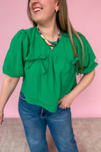 Load image into Gallery viewer, Woman wearing a green blouse with puff sleeves against a pink background