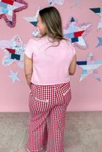 Load image into Gallery viewer, Person wearing a pink top and red checkered pants standing in front of a star-patterned wall.
