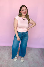 Load image into Gallery viewer, Girl wearing a pink cap sleeve top and denim jeans, standing in front of a pink backdrop.