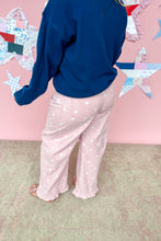 Load image into Gallery viewer, Person wearing a blue sweatshirt and pink pants with star patterns in front of a pink wall with star decorations.