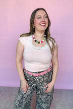 Load image into Gallery viewer, Girl wearing a pink baby tee with lace and leopard barrel pants with pink belt standing in front of a pink backdrop.