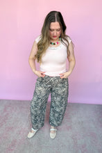 Load image into Gallery viewer, Girl wearing a pink baby tee with lace and leopard barrel pants with pink belt standing in front of a pink backdrop.