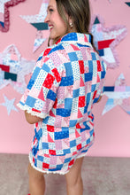 Load image into Gallery viewer, Woman wearing a colorful patchwork dress in front of a pink background with star decorations.