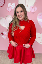Load image into Gallery viewer, Woman wearing a red dress with a red sweater with a heart design against a pink background with heart shapes.