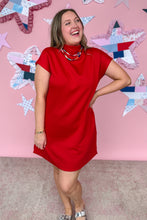Load image into Gallery viewer, Woman in a red dress standing in front of a pink wall with star patterns