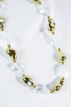 Load image into Gallery viewer, Necklace with gold and clear beads on a white background