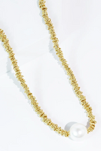 Load image into Gallery viewer, Gold necklace with a pearl on a white background