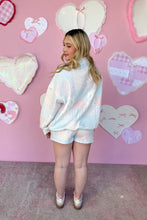 Load image into Gallery viewer, Person wearing a quilted sweater and shorts in front of a pink wall with heart decorations back view