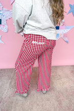 Load image into Gallery viewer, Person wearing red and white checkered pants and a gray sweatshirt against a pink wall with star decorations.
