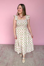 Load image into Gallery viewer, Woman wearing a green and pink floral midi dress against a pink background

