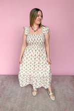 Load image into Gallery viewer, Woman wearing a pink and green floral midi dress against a pink background
