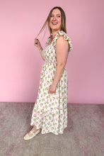 Load image into Gallery viewer, Woman wearing a pink and green floral midi dress against a pink background side view
