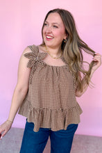 Load image into Gallery viewer, Girl wearing a brown gingham babydoll tank with dark denim jeans in front of a pink backdrop. 
