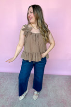 Load image into Gallery viewer, Girl wearing a brown gingham babydoll tank with dark denim jeans in front of a pink backdrop. 
