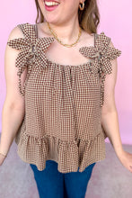Load image into Gallery viewer, Girl wearing a brown gingham babydoll tank with dark denim jeans in front of a pink backdrop. 
