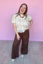 Load image into Gallery viewer, Girl wearing brown wide leg pants with cream and brown polkadot top in front of a pink backdrop.
