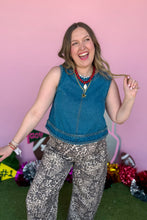 Load image into Gallery viewer, Girl wearing a denim braided tank with leopard barrel jeans standing in front of a pink game day backdrop.
