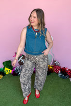 Load image into Gallery viewer, Girl wearing a denim braided tank with leopard barrel jeans standing in front of a pink game day backdrop.

