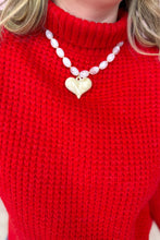Load image into Gallery viewer, Person wearing a red sweater with a Resin necklace featuring a gold heart pendant.
