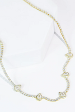 Load image into Gallery viewer, Gold necklace with pear shaped gems on a white background
