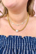 Load image into Gallery viewer, Close-up of a person wearing a blue striped top and gold necklaces with pearls and teardrop gems. 
