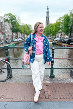 Load image into Gallery viewer, Girl standing in front of a canal wearing a denim polka dot jacket with pink bow top and white barrel jeans 
