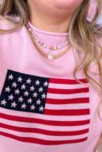 Load image into Gallery viewer, Pink sweater with American flag design worn by a person, with a focus on the necklaces.
