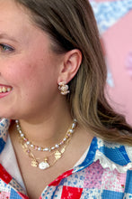Load image into Gallery viewer, Woman wearing pink earrings and necklaces with a colorful background
