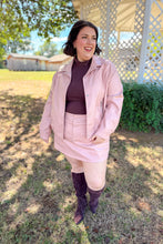 Load image into Gallery viewer, Girl wearing a faux pink leather jacket and skort set with brown undershirt and brown knee high boots standing in front of a gazebo. 
