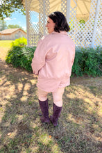 Load image into Gallery viewer, Girl wearing a faux pink leather jacket and skort set with brown undershirt and brown knee high boots standing in front of a gazebo. 
