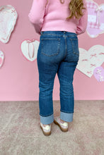 Load image into Gallery viewer, Person wearing blue jeans and a pink sweater against a pink wall with heart decorations back view
