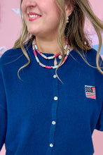 Load image into Gallery viewer, Person wearing a blue cardigan with an American flag patch, pink pants, and Pink double layer beaded necklace against a pink background.
