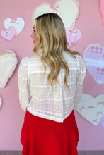 Load image into Gallery viewer, Woman wearing a white lace top and red skirt with a pink heart-themed background back view
