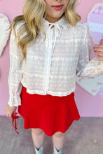 Load image into Gallery viewer, Person wearing a white lace blouse and red skirt with a pink background close up view

